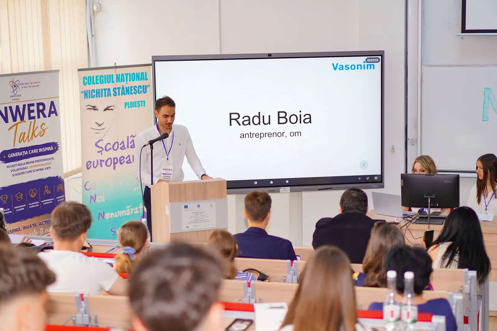 Radu Boia speaking at NWERA Talks, a Vasonim slide on the screen behind him